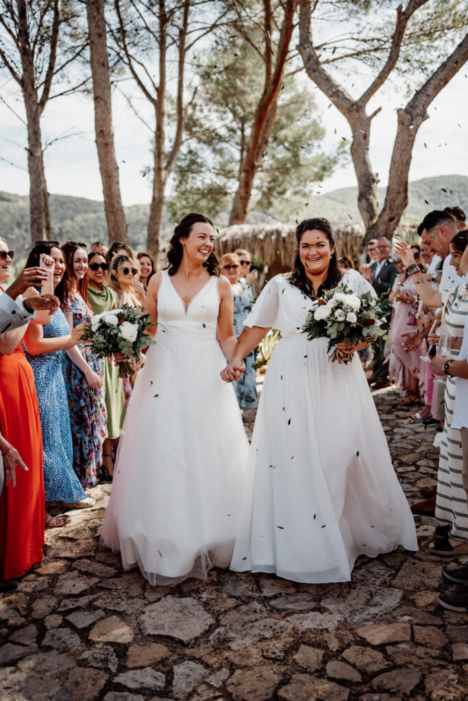 Guests showering two newlyweds with confetti
