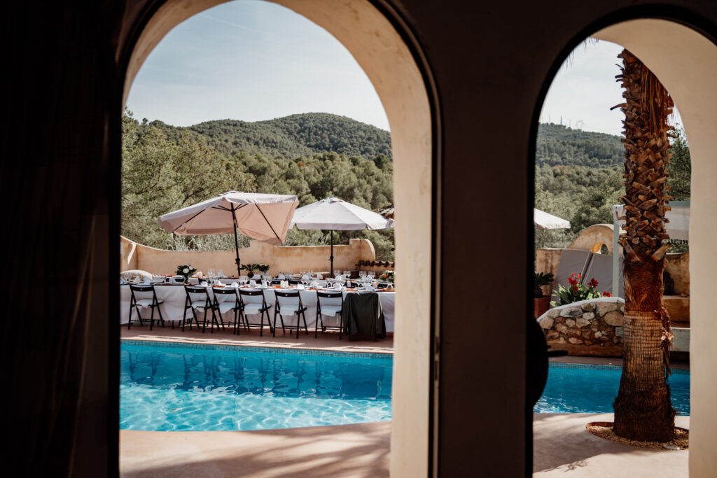 Swimming pool and hillside framed by the villa's arches