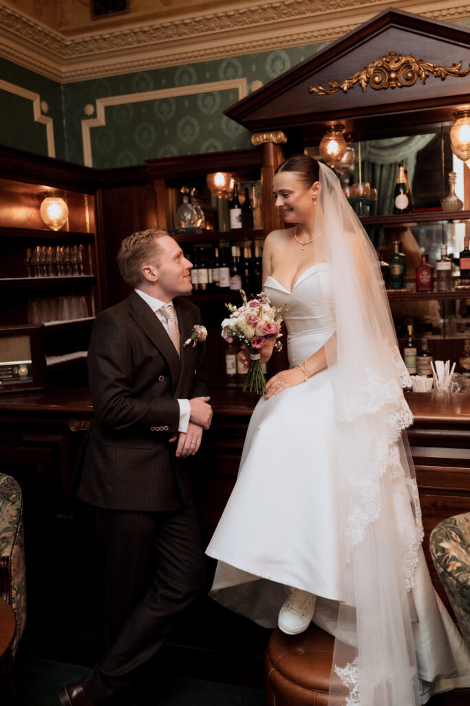 Couple smiling together at the wood-panelled bar
