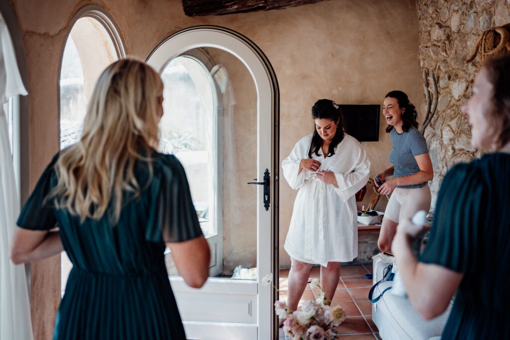 Bride reading aloud to friends gathered in a villa room