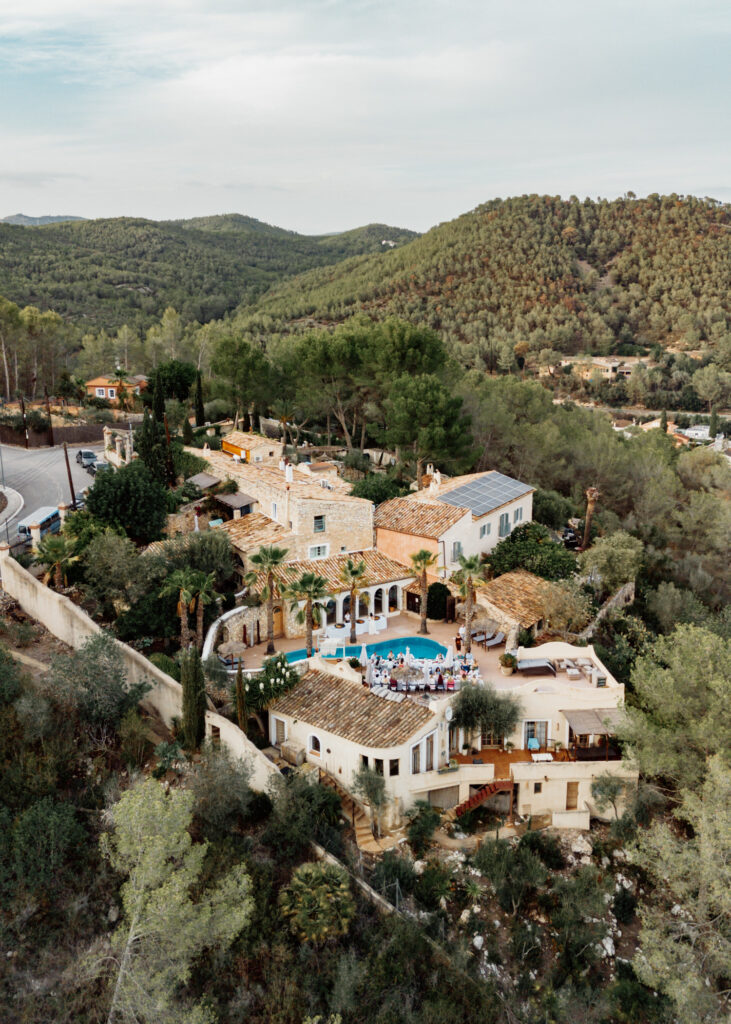 Aerial view of a hillside wedding villa surrounded by woodland