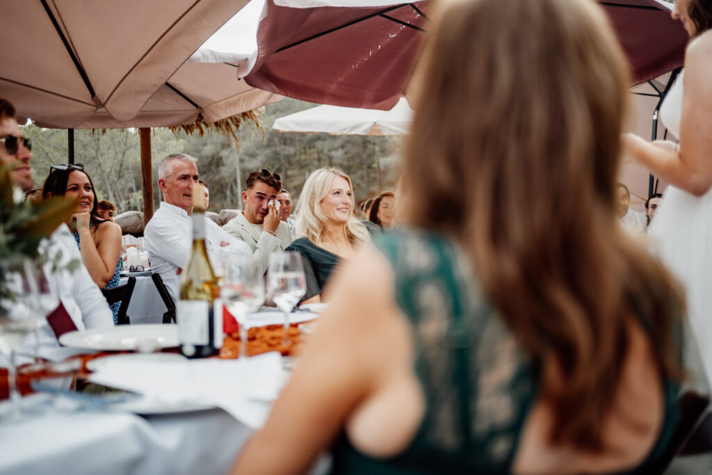 Wedding speech viewed from behind a seated guest