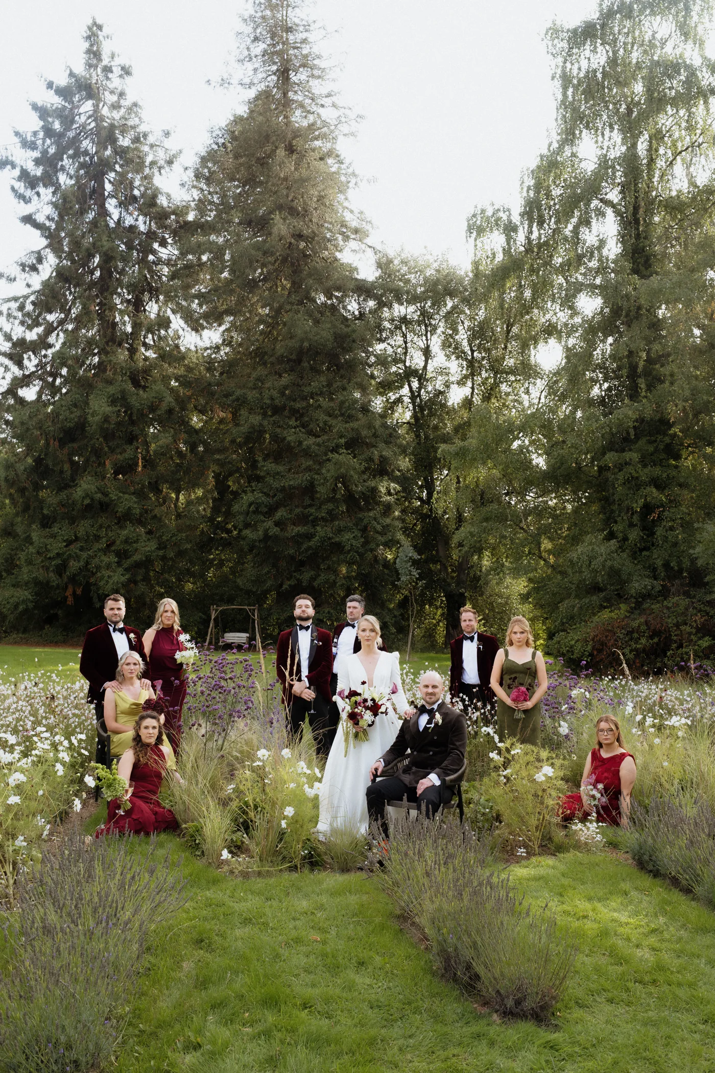 Wedding party gathered in a flower-filled garden