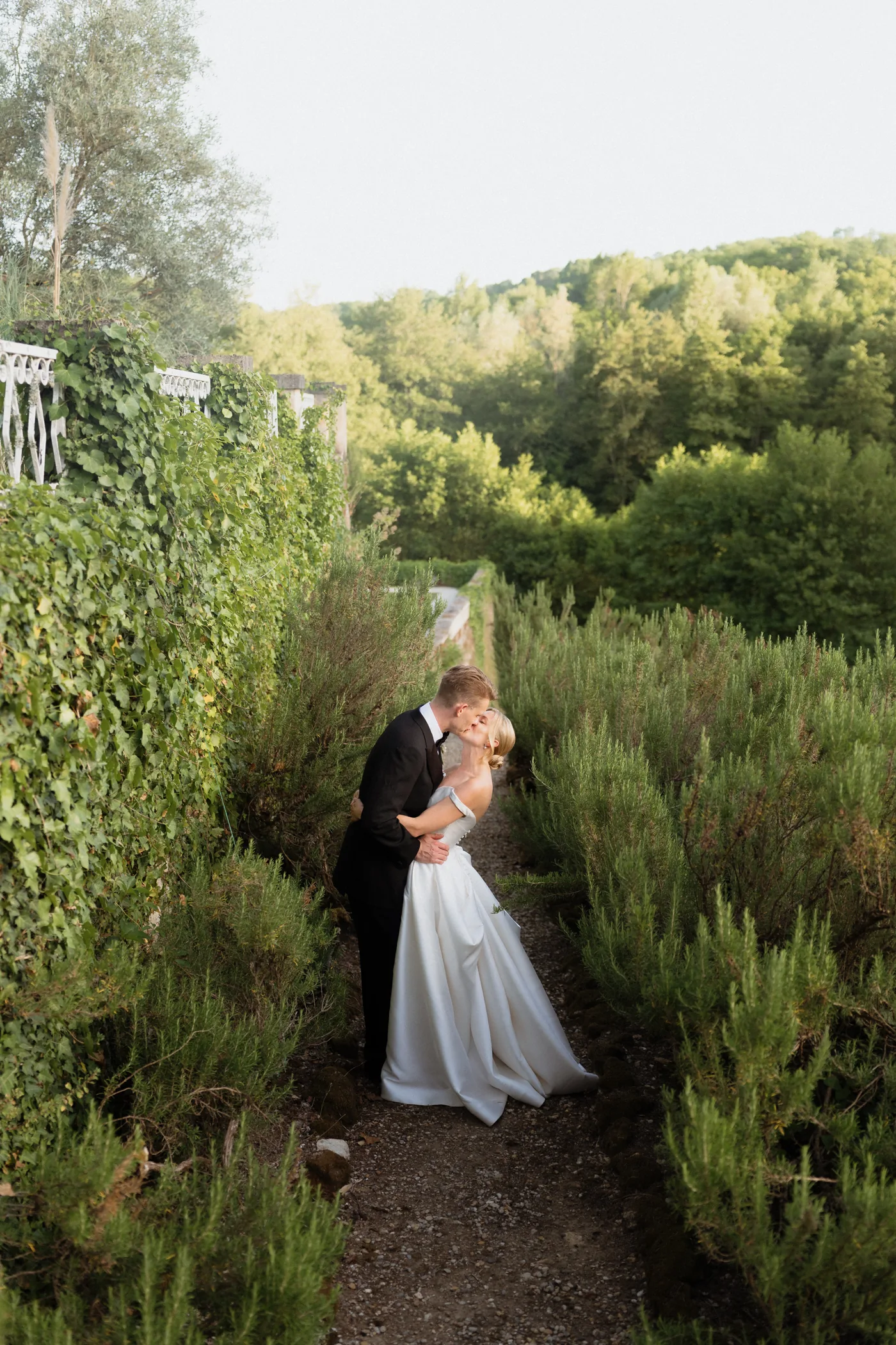 Couple kissing on a garden path