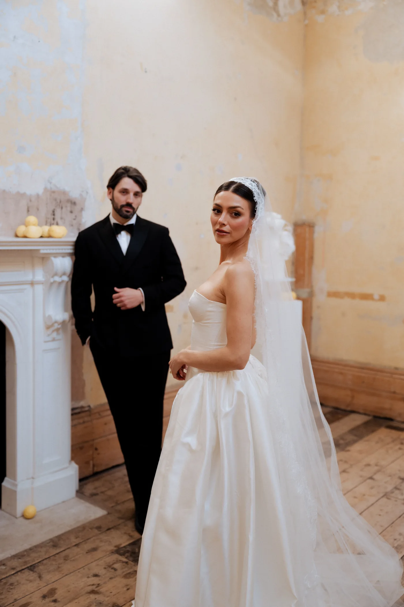 Bride and groom in a warmly lit room at Old Sessions House