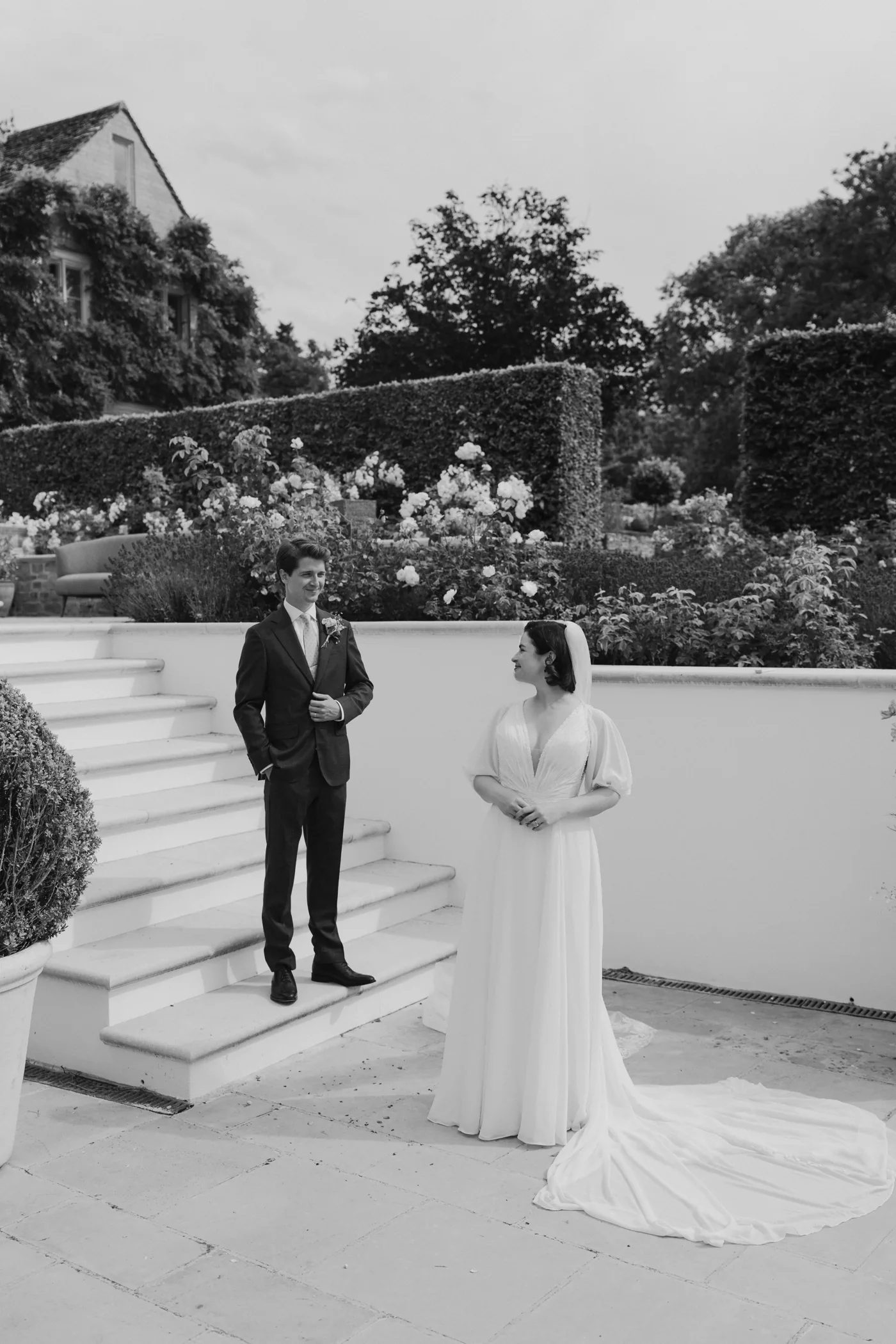 Black-and-white portrait of Rosie and Calum beside garden steps