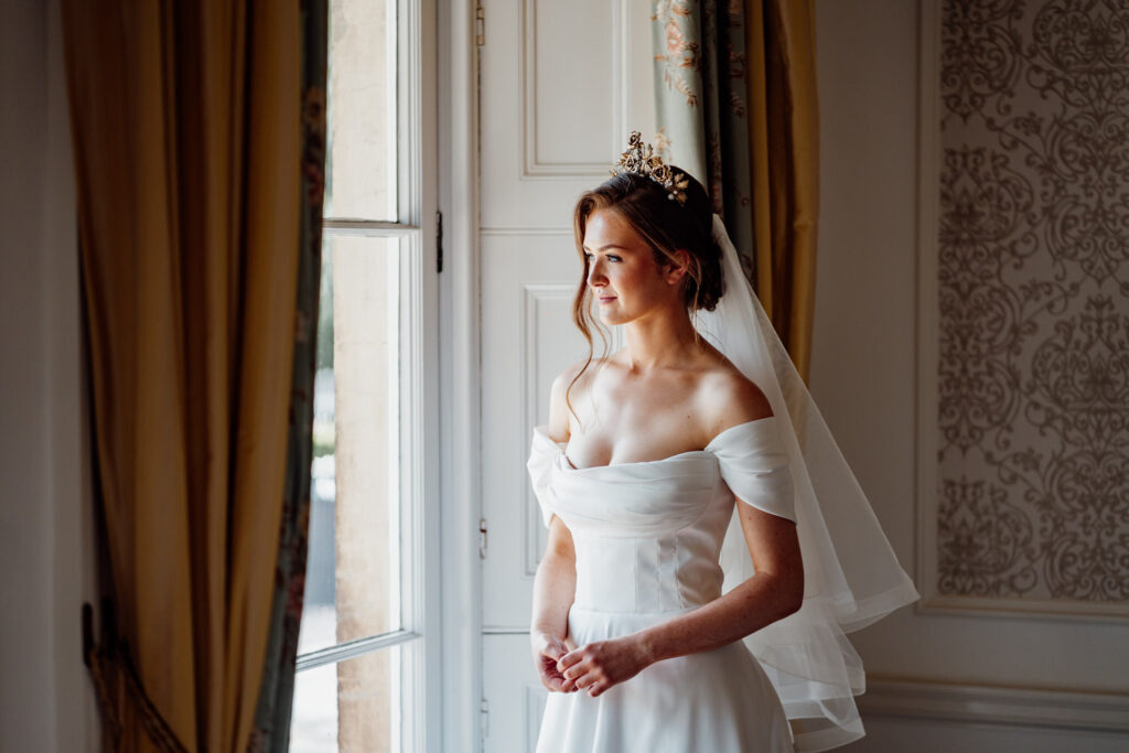 Bride looks out of a window