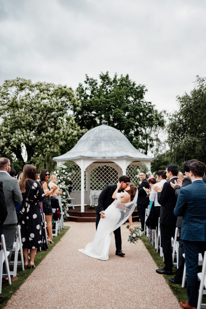 Bride and groom having a dip kiss at Hodsock Priory