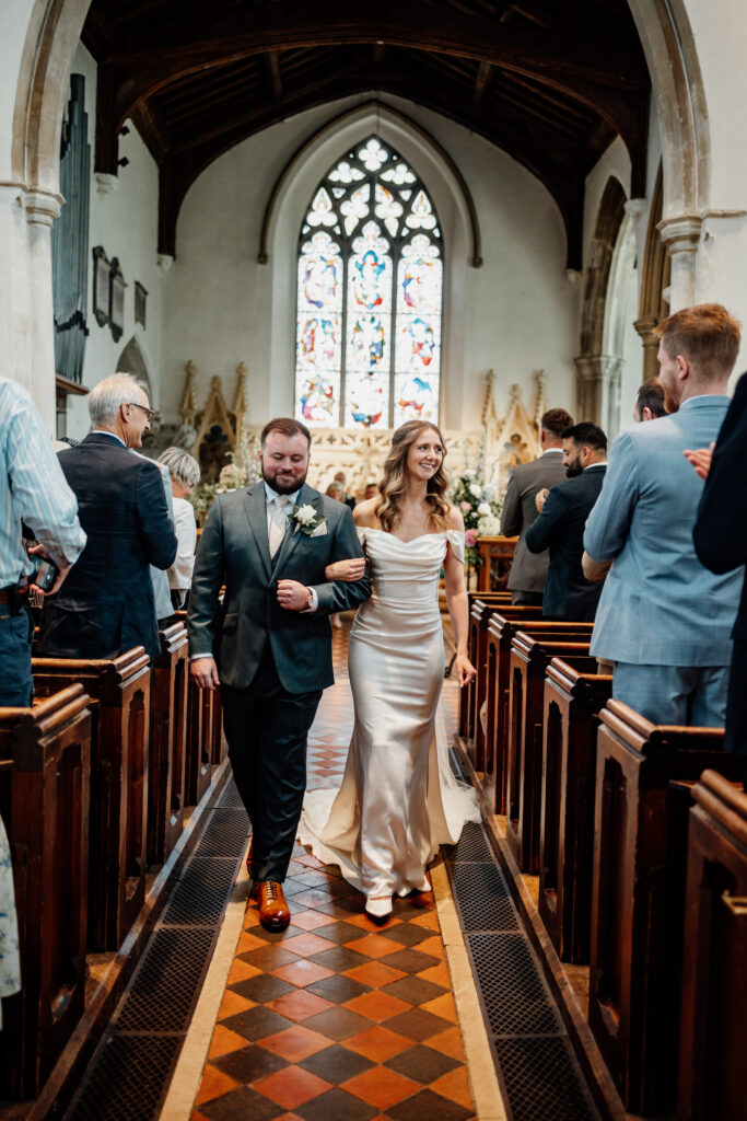 wedding couple walking down aisle in church