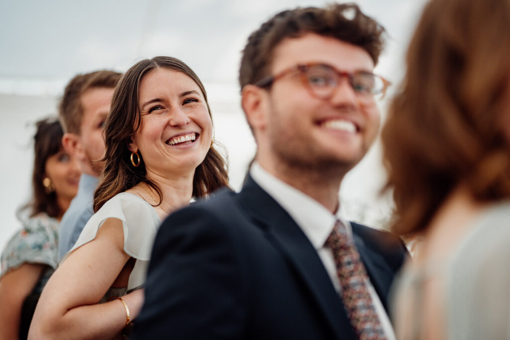 guests laughing at wedding speeches