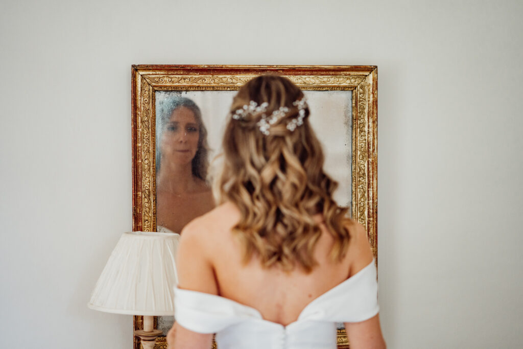 bride looking at herself in mirror