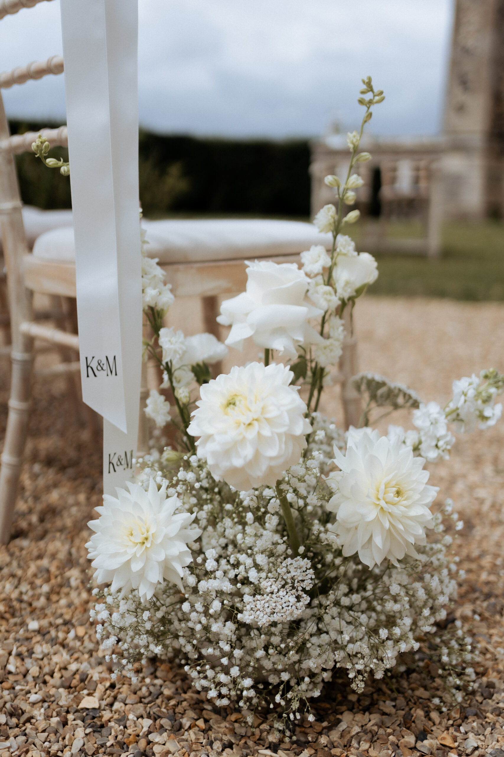 White floral arrangement adorning the ceremony aisle at Pentney Abbey