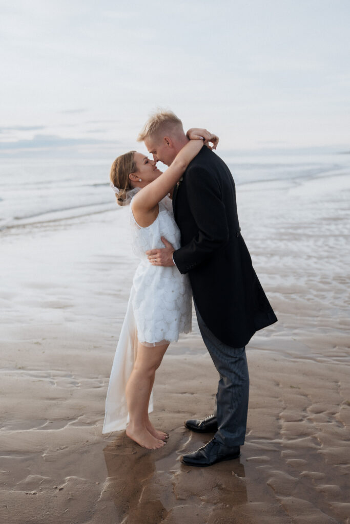 Couple embrace on Isle of Man beach