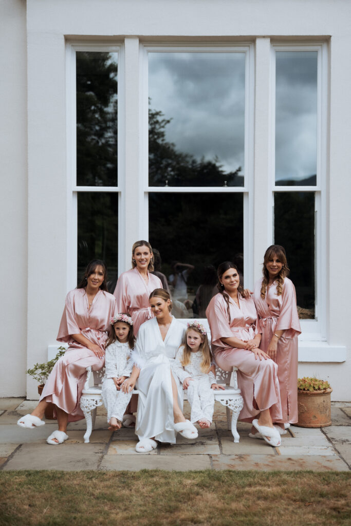 Bridal party group shot in editorial style outside of morning preparation venue
