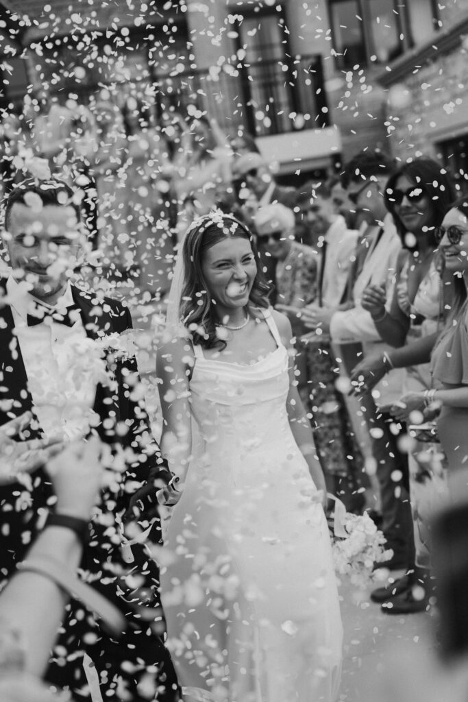 Bride being showered in confetti